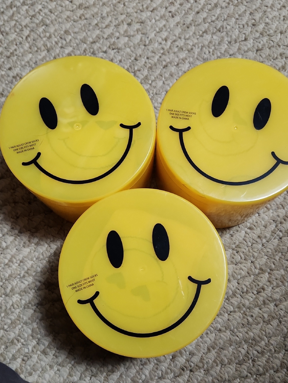3Smiley Face Yellow Storage Containers With A Pair Of Crew Socks Inside